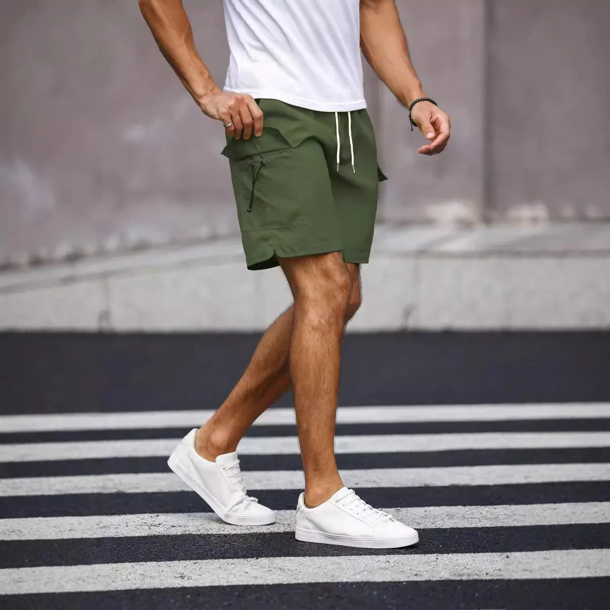 Men's loose fit workwear shorts in fluorescent green or army green with straight leg and fifth-pants length.
