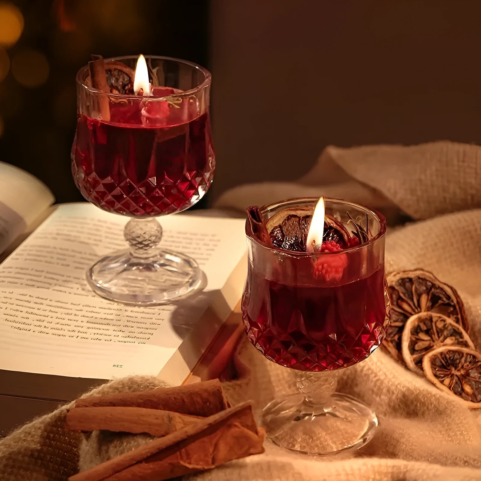 French mulled wine scented candle in a clear glass goblet on a table