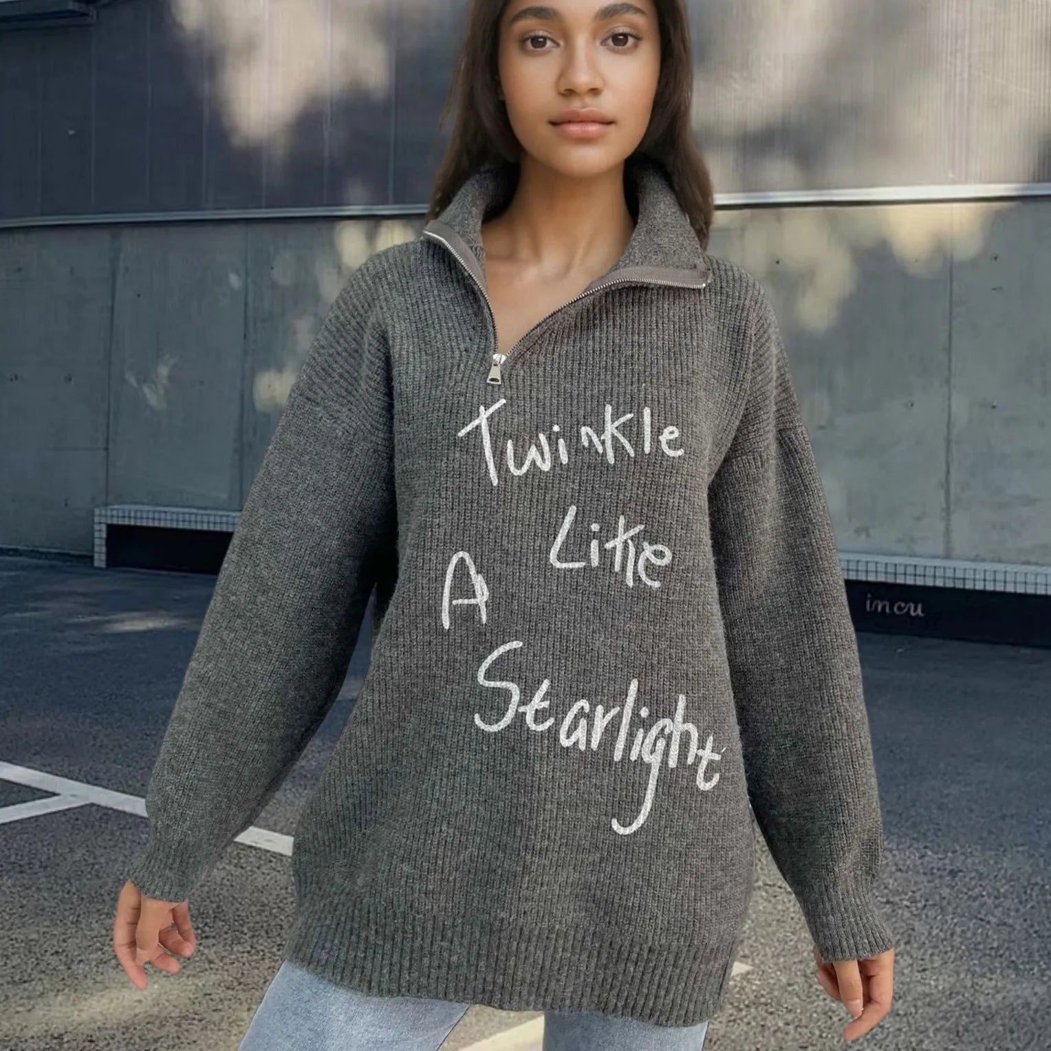 Light khaki women's alpaca wool sweater with a diagonal front zip and loose lapel turtleneck collar.