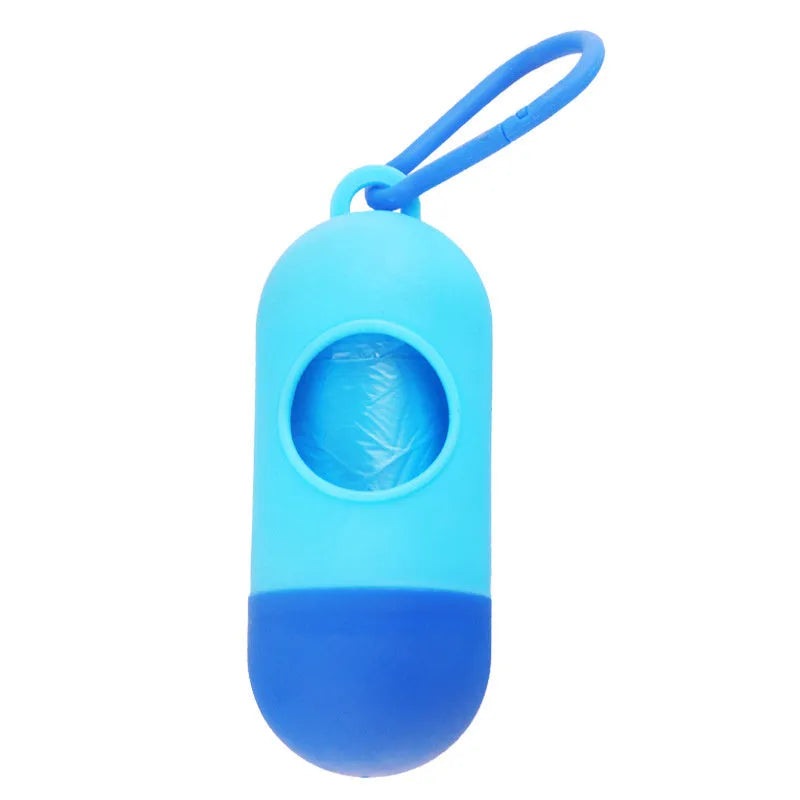 Black plastic dog poop bag holder with a metal side hook and Velcro strap, showing compact size.