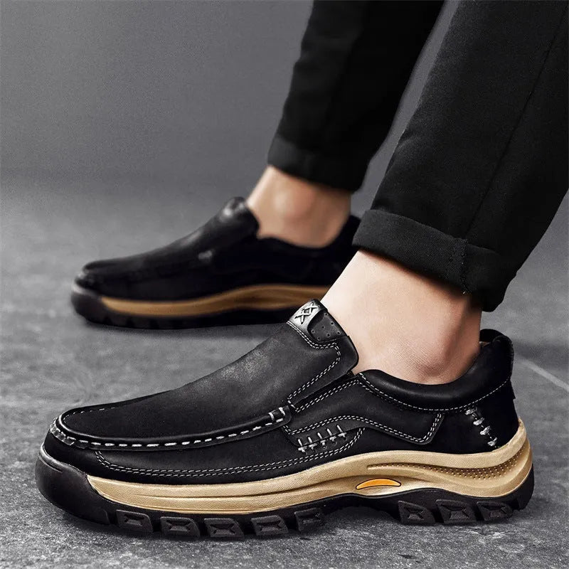 Men's black thick-soled mountaineering boots with round toe and rubber sole.