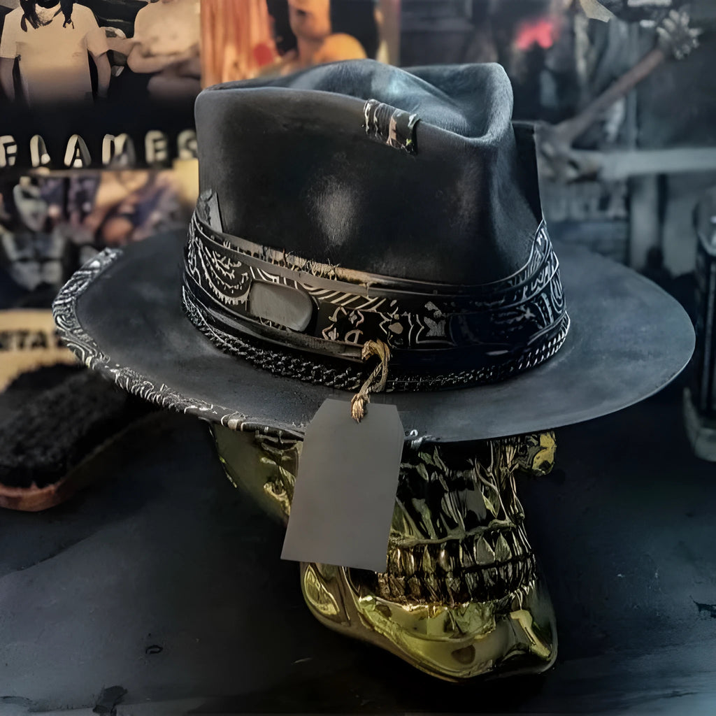 Handmade black skull hat with conical crown, made from wool and denim fabric, on a neutral background.