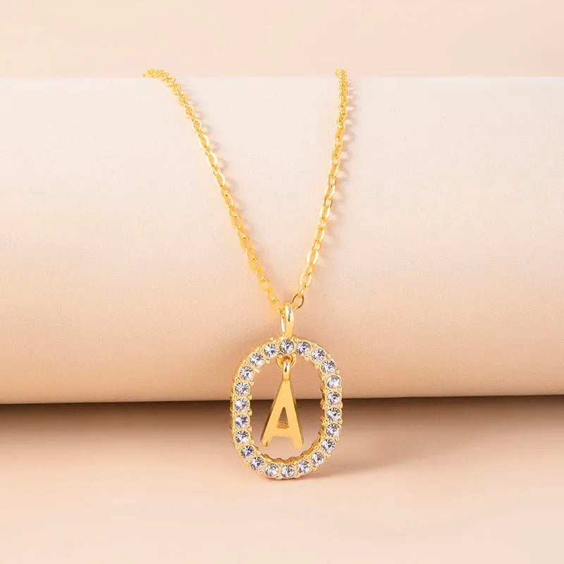 Gold crystal letter initial oval pendant necklace on woman, rhinestone letter in zinc alloy frame with adjustable chain