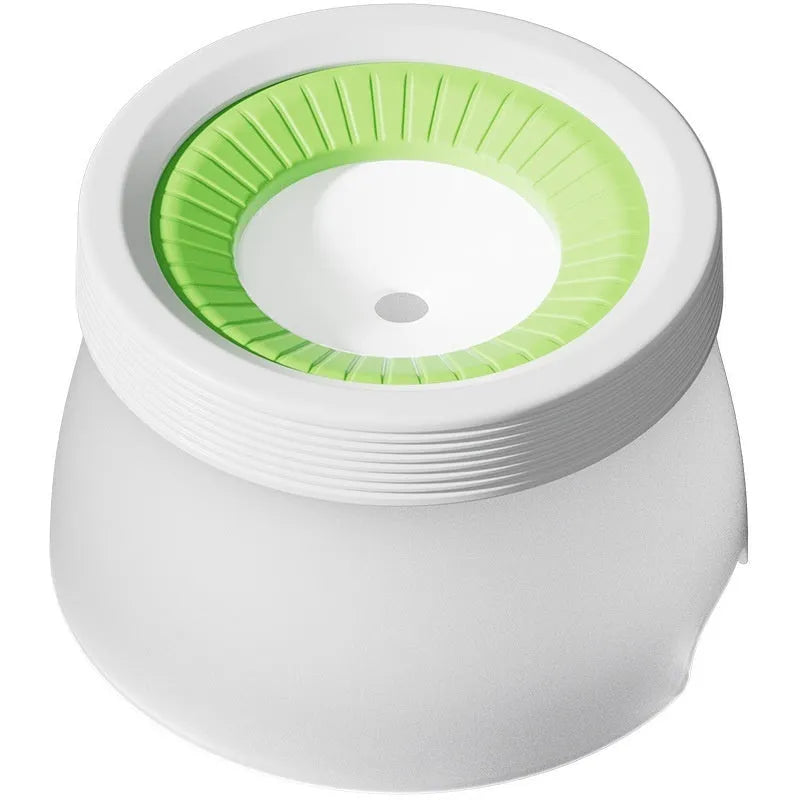 Green raised suspension water bowl for a dog on a white plate