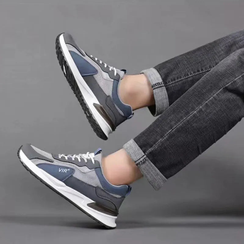 Men's colour block mesh sneakers in black, grey, and white with round toe and flat heel.