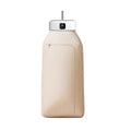 White cylindrical compact foldable laundry dryer with remote control on a table.