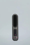 A white portable negative ion hair comb with USB-C charging port, shown alongside dark blue and grey colour options.