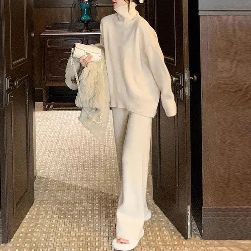 Women's casual two-piece set showing sweater and wide leg trousers in solid colour with thread detail