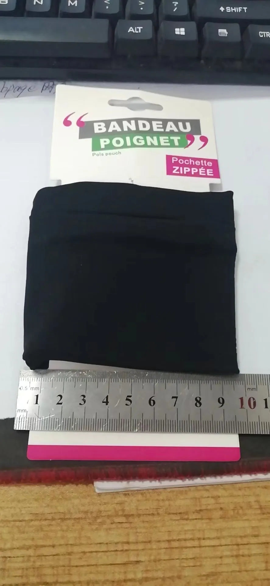 Black wrist bag armband sleeve for mobile phone storage, shown on a wrist.