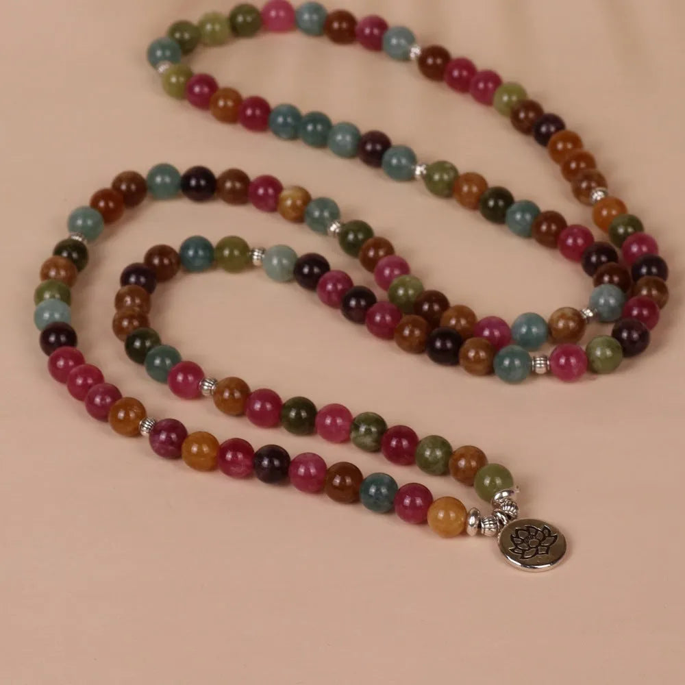 108 bead string bracelet with lotus charm in tourmaline-coloured alloy