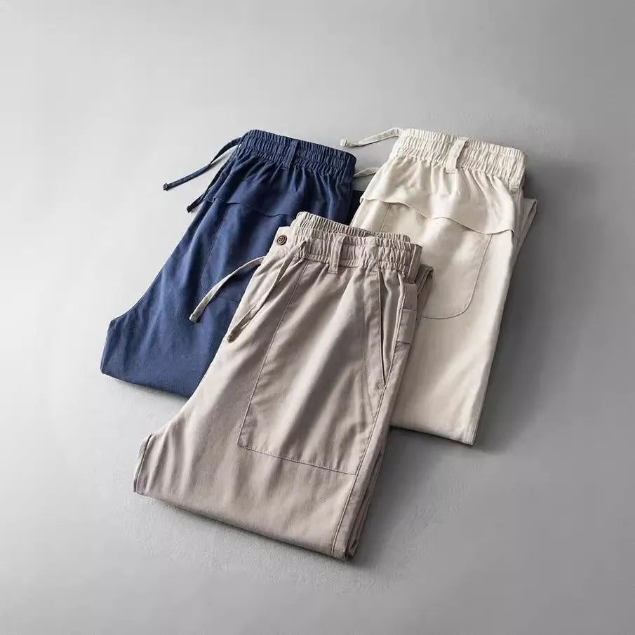 Men's solid colour linen casual trousers in navy blue, shown from the front.