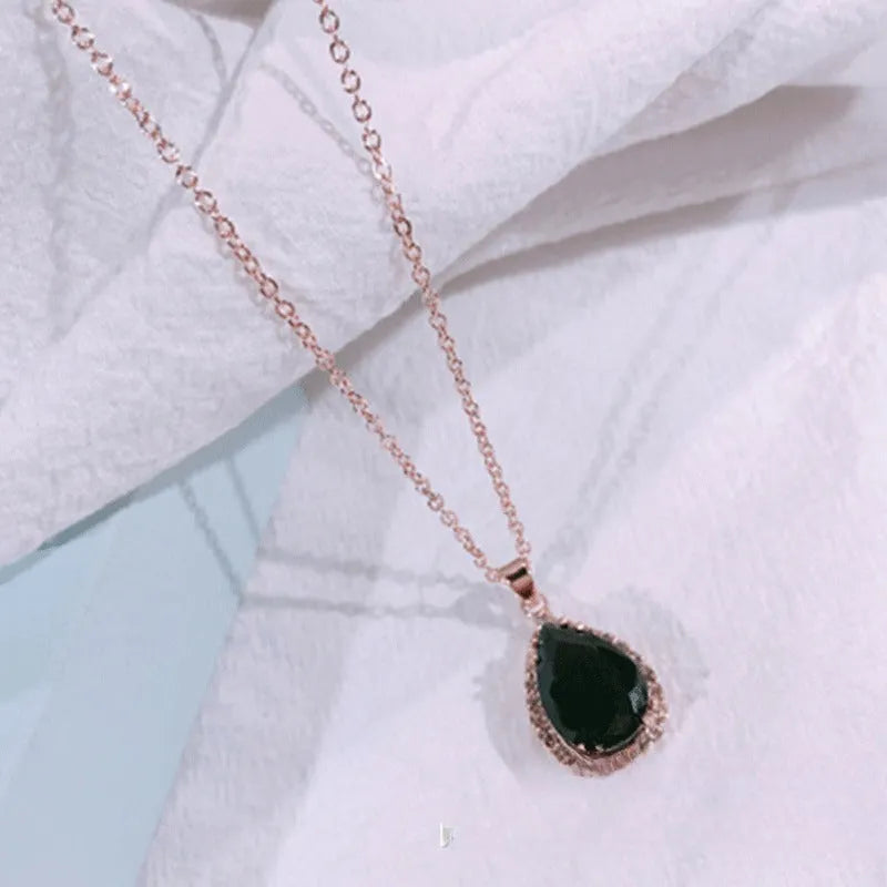 Rose gold geometric drop necklace with rhinestone details in pink colour option