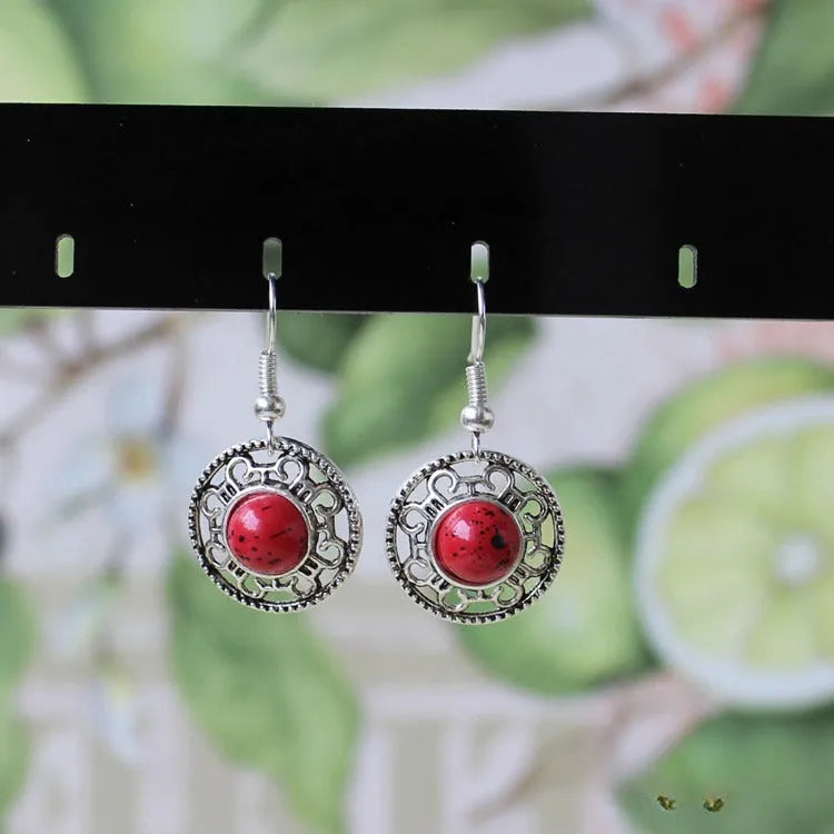 Handmade geometric flower disk earrings in Tibetan silver and turquoise with ethnic Miao design.