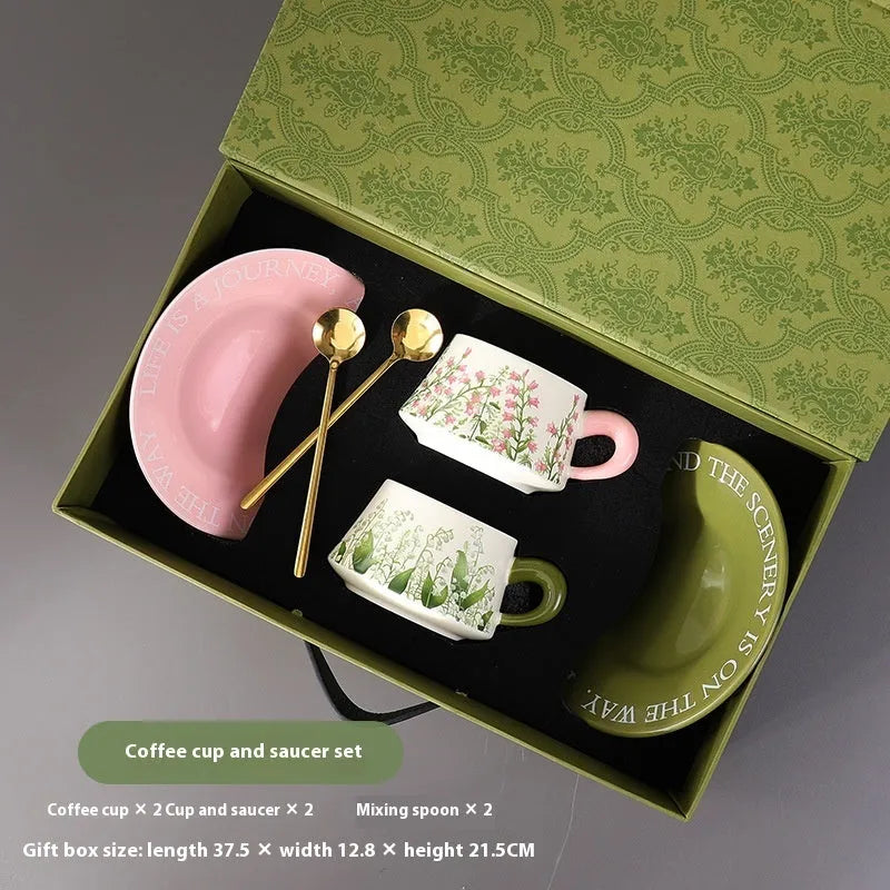 Ceramic coffee cup and saucer set for two with matching spoons in bell-shaped design