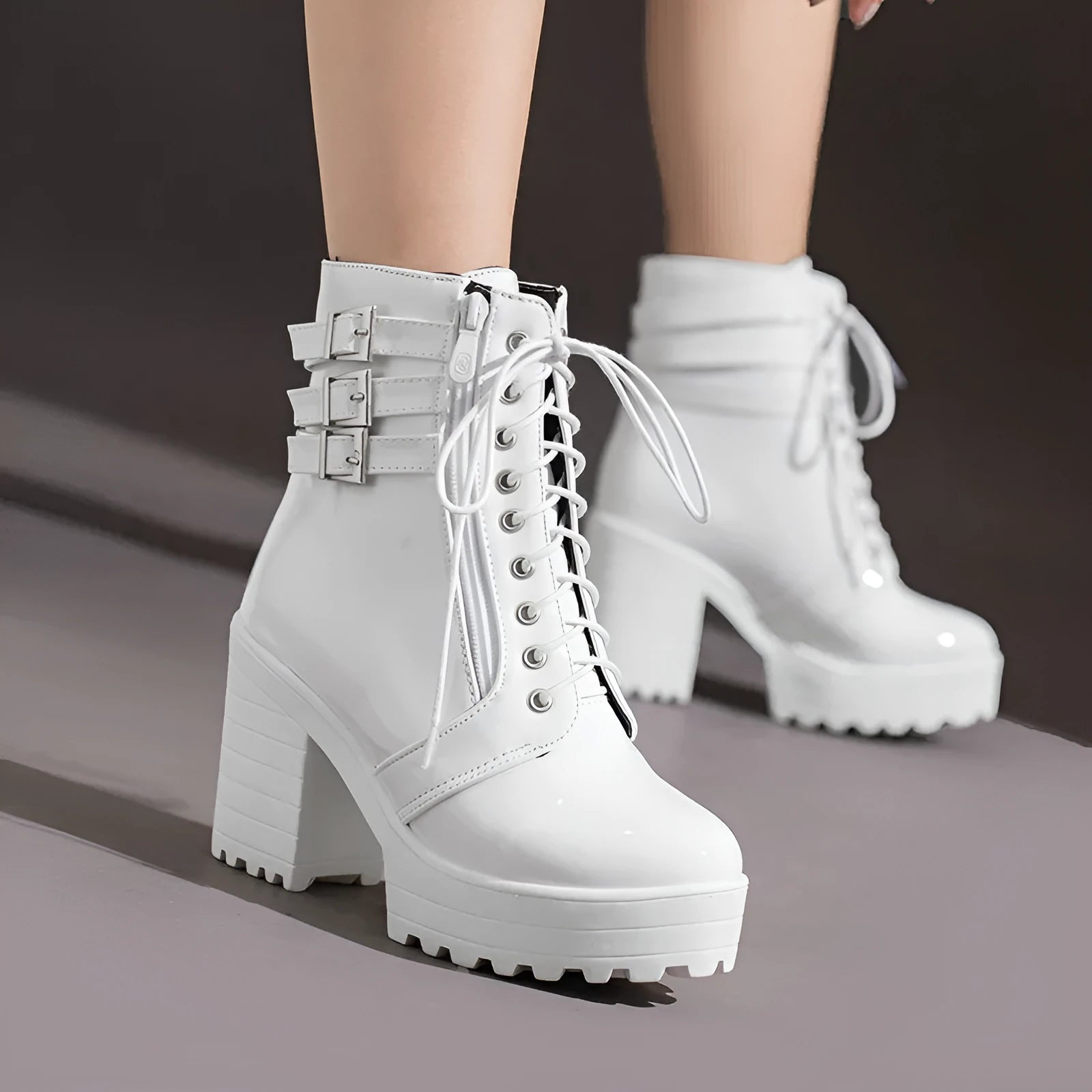 Women's black thick-heeled short boots with lace-up front and round toe on a waterproof platform.
