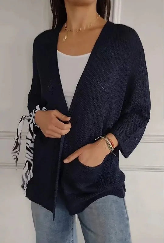 Women's army green waffle knit cardigan coat with nine-quarter sleeves and pockets.