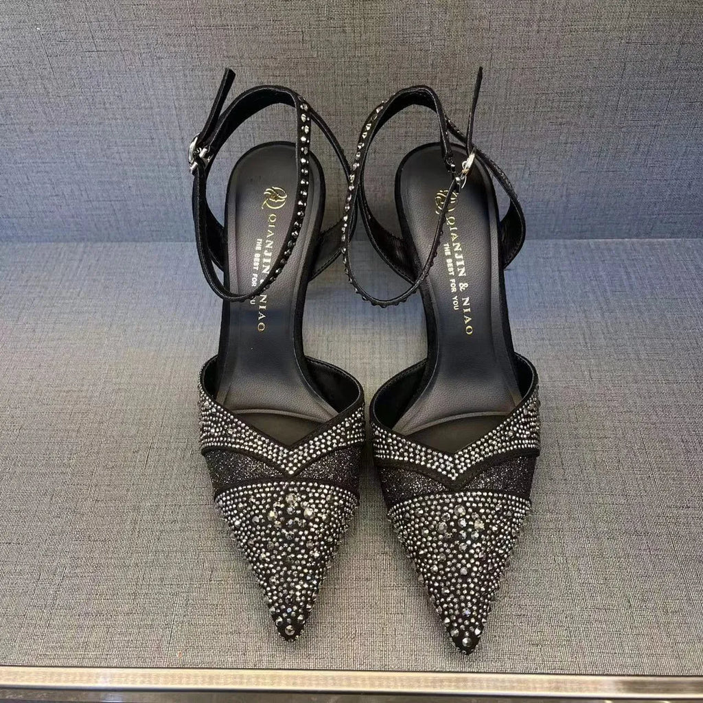 Women's black and silver hollow high heels with red soles, stiletto heels, and pointed toe design
