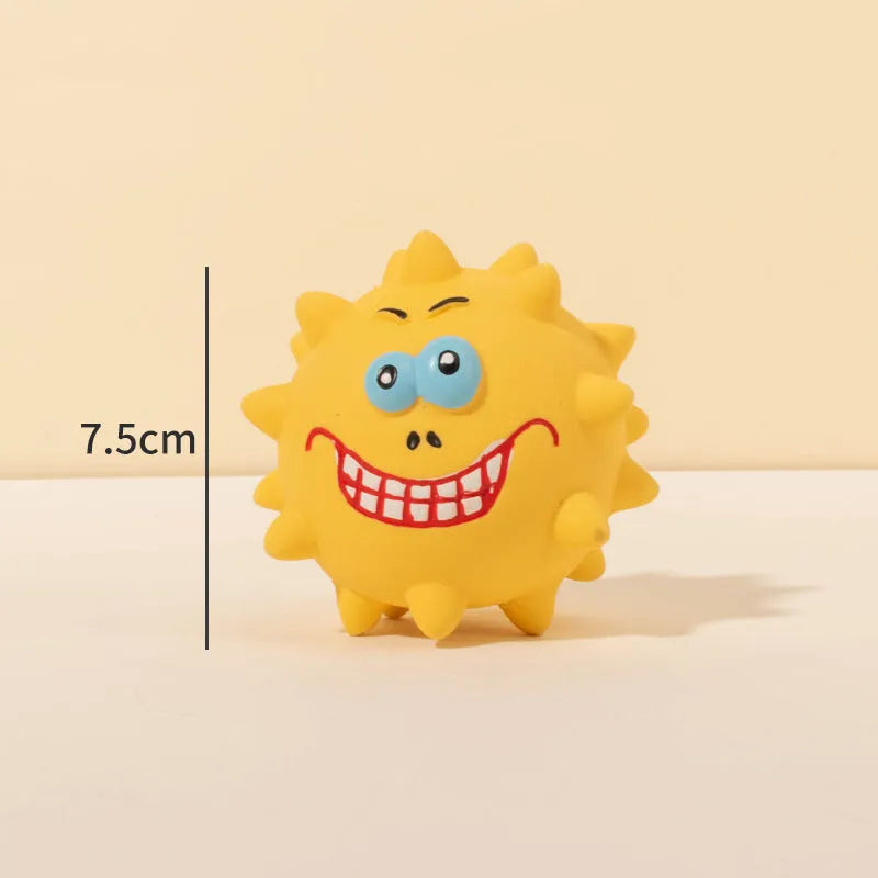 Set of four coloured latex squeaky dog balls with cute faces on a bumpy surface.