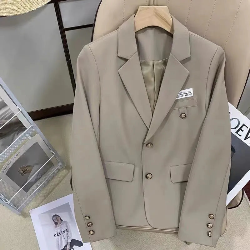Black women's loose-fit suit coat with long sleeves and a pocket, made from polyester.