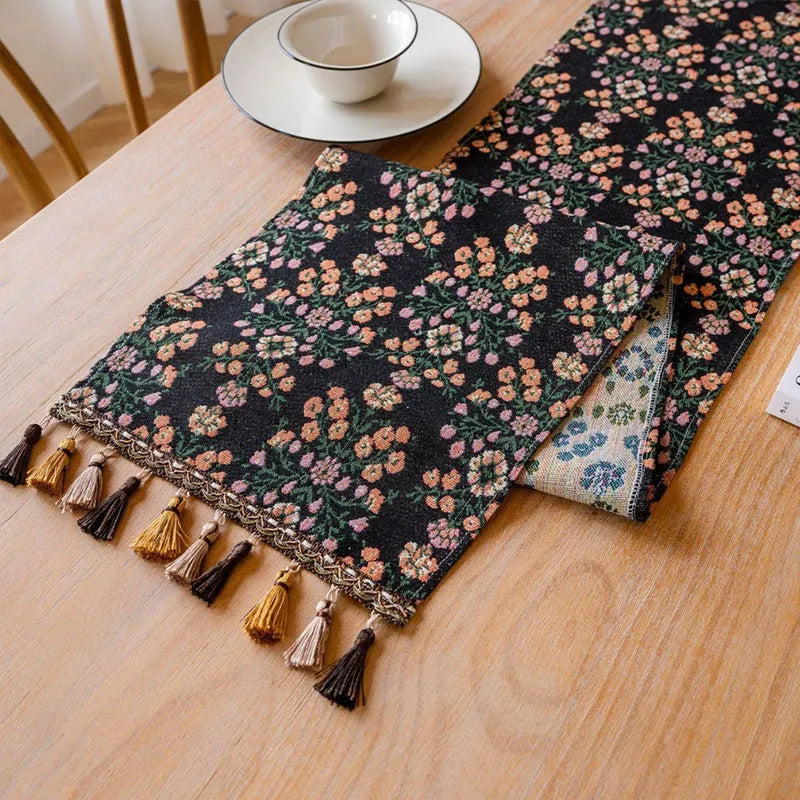Nordic jacquard bouquet pattern table runner with decorative tassel trim in dark blue colour