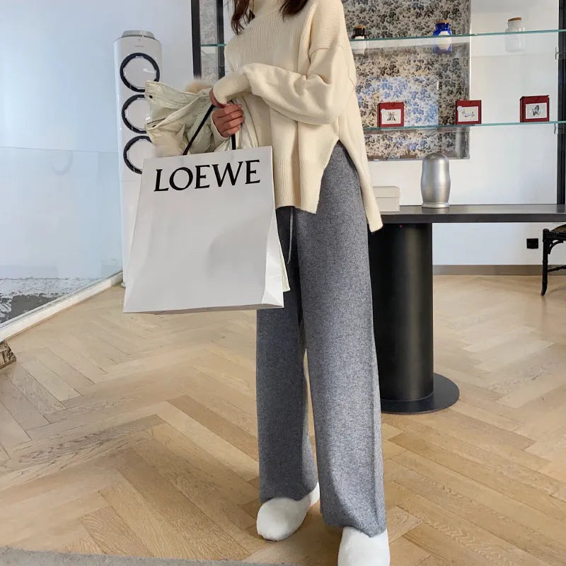 Women's high-waist knitted wide-leg trousers in a cream white colour, showcasing the straight-leg mopping style.