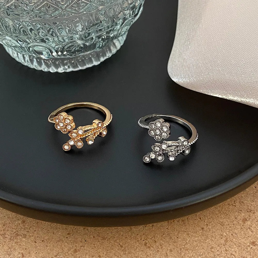Copper open-ring with diamond-treated floral pattern and leaf details in gold colour