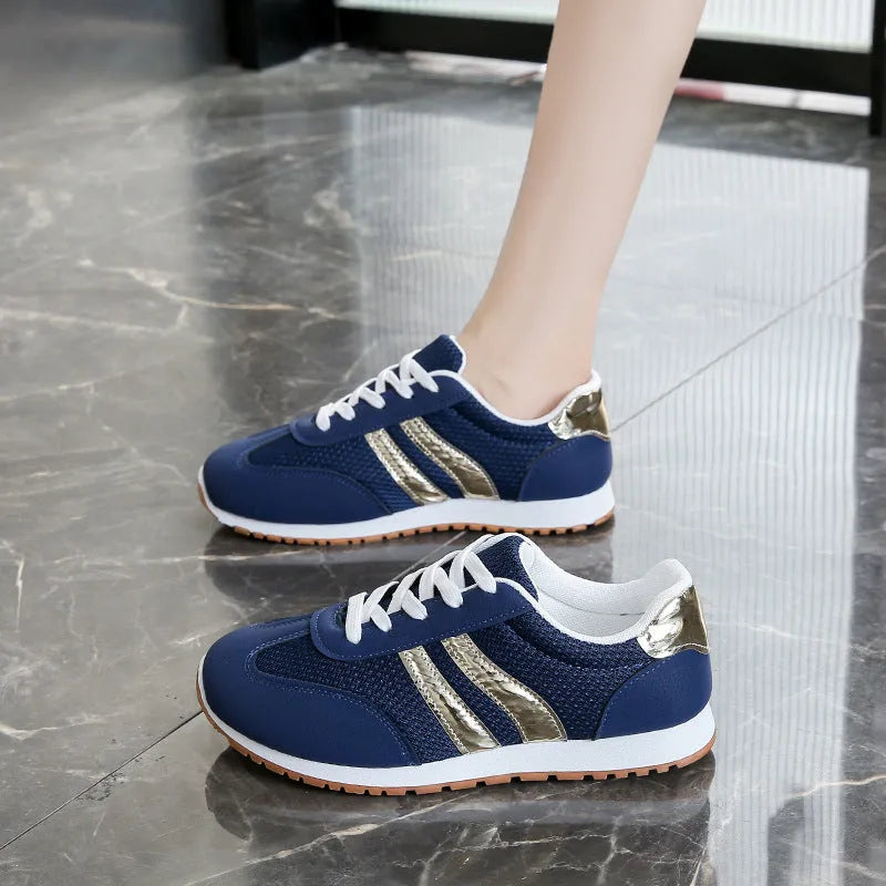 Blue women's sports shoes with cross shoulder straps, round toe, and flat rubber sole.