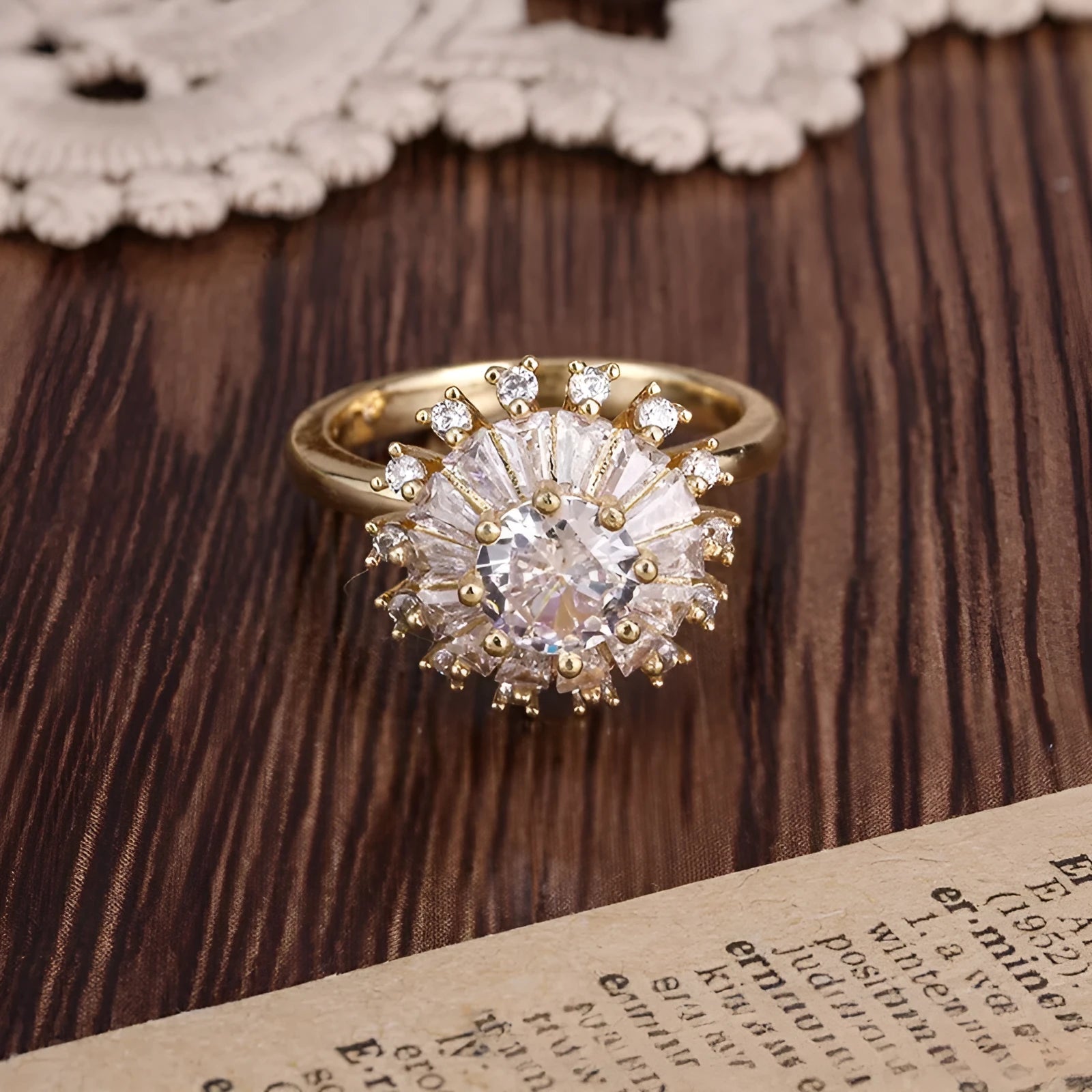 Gold electroplated copper flower ring with open mouth design on a plain background