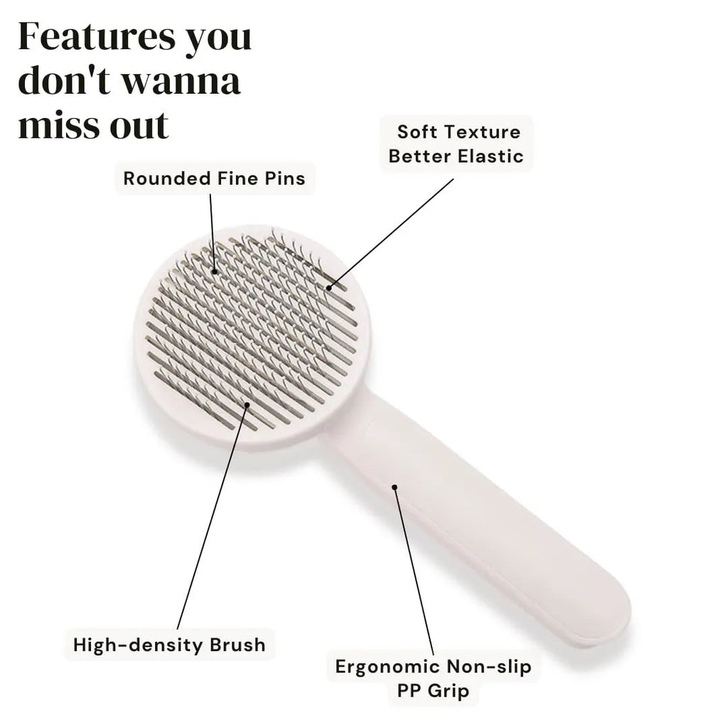 Blue self-cleaning slicker brush for dogs and cats on a table, showing ergonomic rubber handle and stainless steel pins.