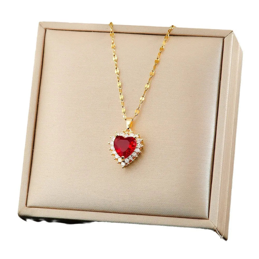Gold red titanium steel necklace, earrings, and ring set with heart flower pendants and gem inlays.