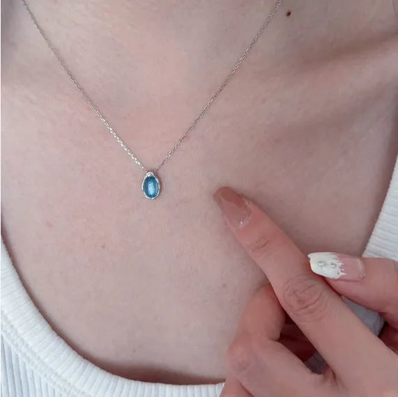 Navy blue water drop pendant necklace with platinum-colour finish on adjustable copper cross chain.
