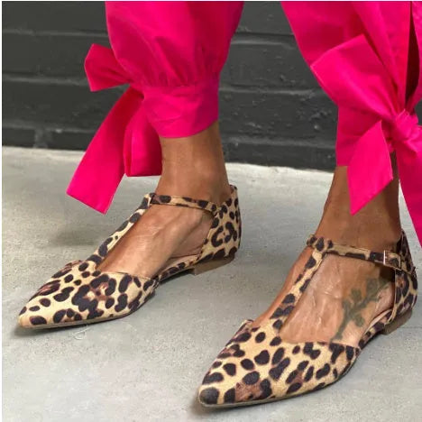 Leopard print women's pumps with pointed toe and chunky low heel, featuring cross shoulder straps