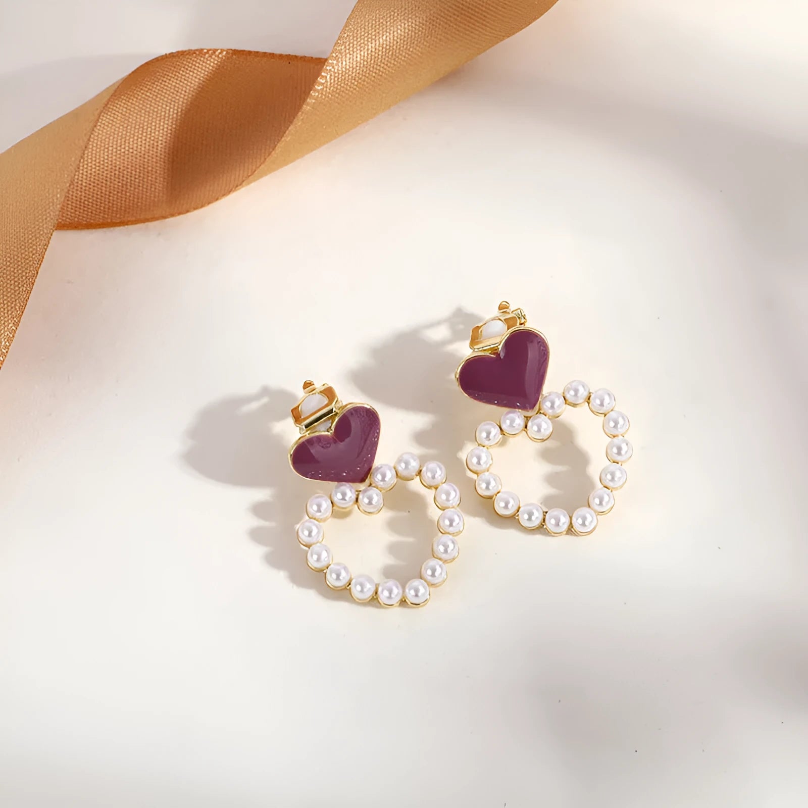 Gold geometric clip-on tassel earrings for non-pierced ears on white background