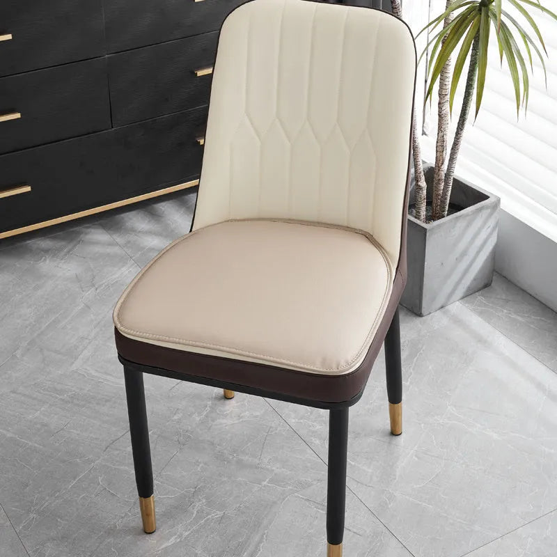 Leather horseshoe-shaped seat cushion in beige colour showing curved design and non-slip underside