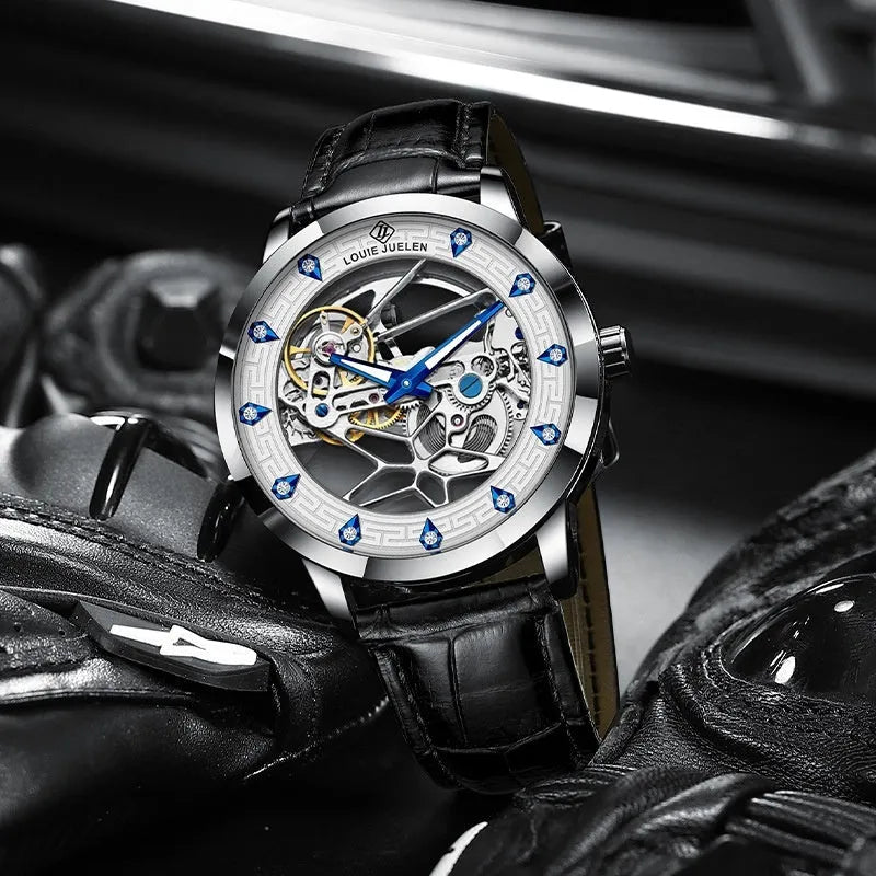Men's silver mechanical watch with white dial, blue hands, black leather strap, and stainless steel butterfly buckle