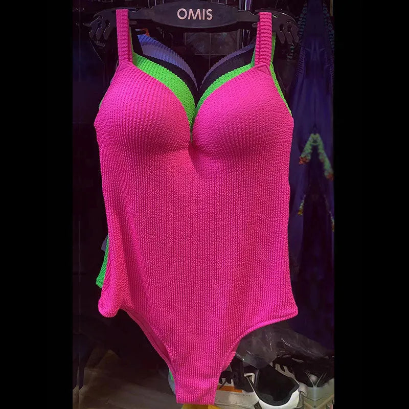 Women's black sunk stripe one-piece swimsuit made from polyester, shown on a mannequin.