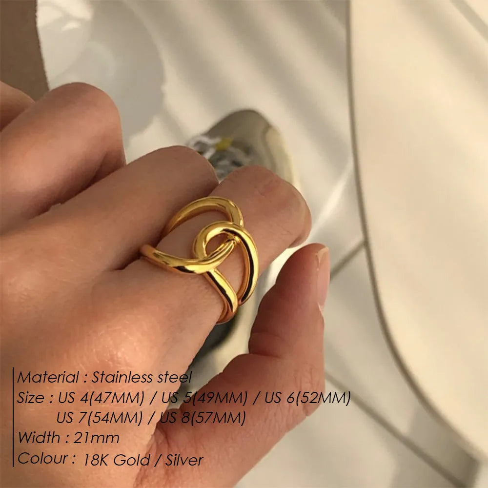 Adjustable stainless steel ring with knotted geometric design in gold or steel colour on finger