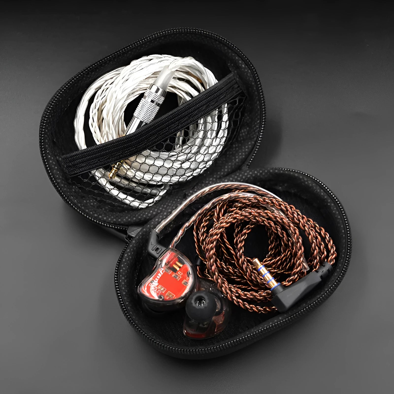 Black leather oval-shaped earphone storage pouch for portable headphones.