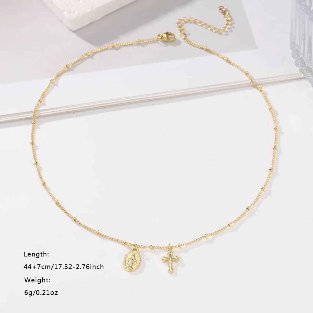 Geometric Cross Virgin Mary pendant necklace in gold on a simple chain.