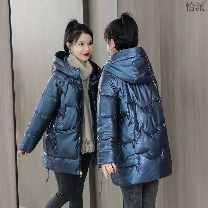 Woman wearing a loose-fit green hooded winter jacket with long sleeves.