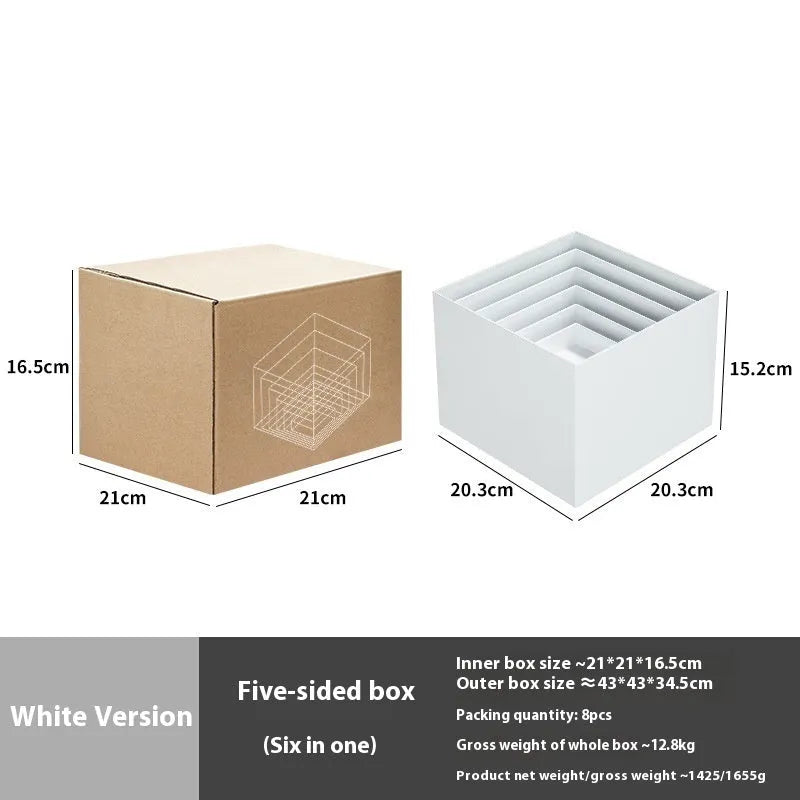 Set of six white geometric cube-shaped plastic dessert display stands arranged on a table.