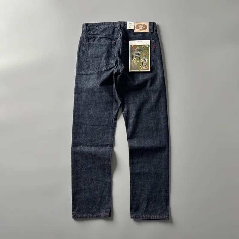 Men's primary colour straight leg denim jeans laid flat, showing mid waist and classic five-pocket design.