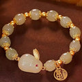 Green jade hare charm bracelet with black hand band showing lily engravings and fu character detail