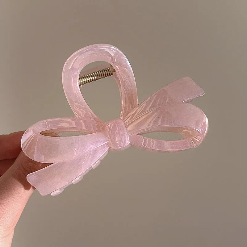 Women's ice bowknot resin hair clip with sweet bow design in blue, pink, and white colour options