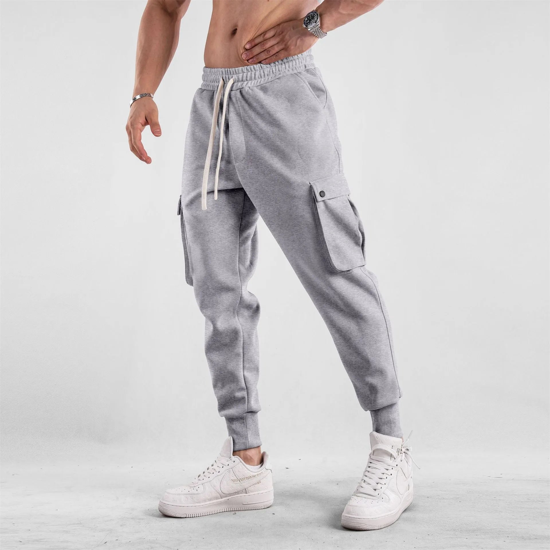 Men's cotton sports trousers with ankle ties and multiple pockets in apricot colour
