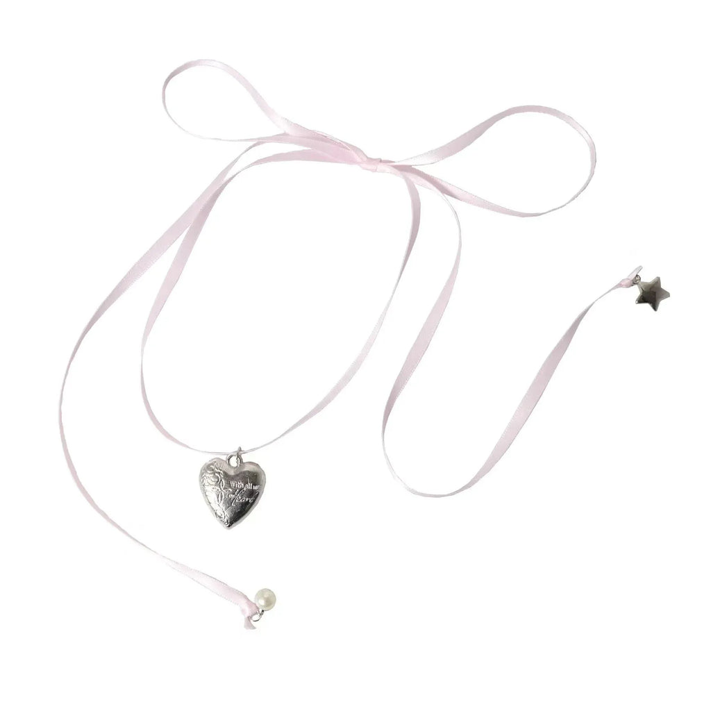 Close-up of a women's alloy love pendant necklace with electroplated finish on a clavicle chain.