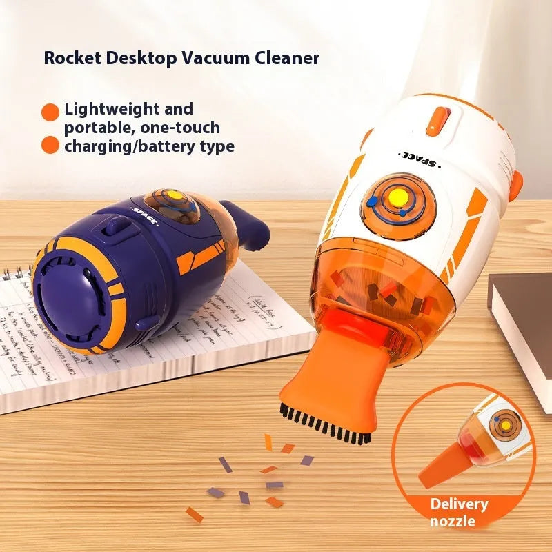 Handheld desktop vacuum cleaner in blue rocket design with USB charging cable on a wooden desk.