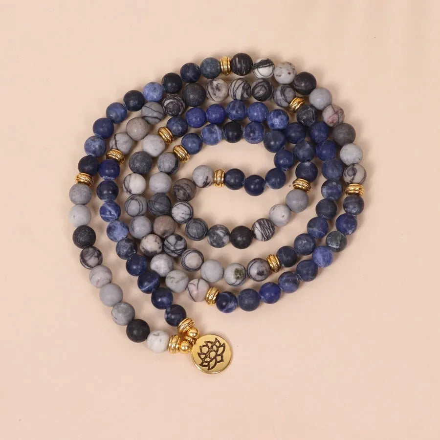 Multi-layer bracelet with blue patterned network stone beads on an alloy base, showing a fresh and sweet natural style.