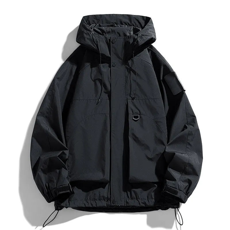 Man wearing a black hooded waterproof windproof jacket with long sleeves.