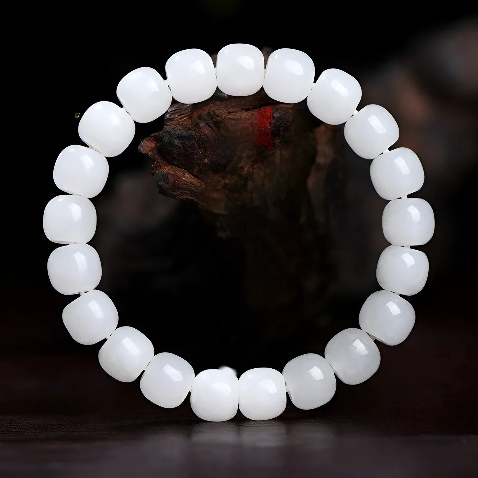White Hetian jade barrel bead bracelet shown in three bead size variations on a wrist.